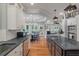Open-concept kitchen with dark island, stainless appliances, and easy access to living spaces at 3601 Colonel Vanderhorst Cir, Mount Pleasant, SC 29466