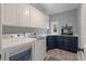 Bright laundry room with washer, dryer, cabinetry and sink for added convenience at 3601 Colonel Vanderhorst Cir, Mount Pleasant, SC 29466