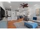 Cozy living room with hardwood floors and a built in bar leading to modern kitchen at 3601 Colonel Vanderhorst Cir, Mount Pleasant, SC 29466
