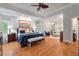 Luxurious main bedroom featuring hardwood floors, tray ceilings, and a cozy sitting area at 3601 Colonel Vanderhorst Cir, Mount Pleasant, SC 29466