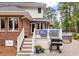 Stylish outdoor patio with white railings and brick accents, featuring a grill and comfortable seating areas at 3601 Colonel Vanderhorst Cir, Mount Pleasant, SC 29466