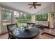 Cozy screened patio featuring wicker furniture and brick flooring, perfect for outdoor relaxation and entertaining at 3601 Colonel Vanderhorst Cir, Mount Pleasant, SC 29466