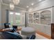 Inviting sitting area with natural light, chairs, an ottoman, and custom shelving at 3601 Colonel Vanderhorst Cir, Mount Pleasant, SC 29466
