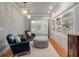 Comfortable sitting area with built-in shelves, chairs, ottoman, and natural light at 3601 Colonel Vanderhorst Cir, Mount Pleasant, SC 29466