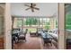 Enclosed sunroom with brick floor, wicker furniture, ceiling fan, and view of the backyard at 3601 Colonel Vanderhorst Cir, Mount Pleasant, SC 29466