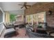 Enclosed sunroom with brick floor, wicker furniture, ceiling fan, and large sliding glass doors at 3601 Colonel Vanderhorst Cir, Mount Pleasant, SC 29466