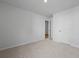 Clean, carpeted bedroom showcasing a bright, neutral color palette, and a doorway leading to another room at 4147 Rising Tide Dr, Summerville, SC 29485