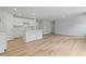 Open-concept kitchen with white cabinets and stainless steel appliances flowing into the living area at 4147 Rising Tide Dr, Summerville, SC 29485