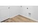 Bright laundry room with white walls and light wood flooring with hookups ready for a washer and dryer at 4147 Rising Tide Dr, Summerville, SC 29485