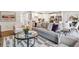 Cozy living room with contemporary sofa, plush cushions, and decorative rug alongside a modern, open kitchen space at 4147 Rising Tide Dr, Summerville, SC 29485