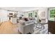 Open-concept living room with natural light and hardwood floors flowing into the dining area and modern kitchen space at 4147 Rising Tide Dr, Summerville, SC 29485