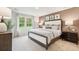 Serene bedroom with natural light, neutral palette, and stylish decor, including an upholstered headboard and modern lighting at 4147 Rising Tide Dr, Summerville, SC 29485