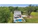 Aerial view of an outdoor pool, backyard patio with bar, and a charming two-story home at 4205 Cobble Trot Way, Johns Island, SC 29455