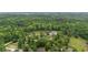 Expansive aerial view of wooded estate with a pond and charming home nestled among mature trees at 4205 Cobble Trot Way, Johns Island, SC 29455