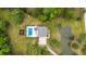 Aerial view of home with backyard pool, pond, and lush greenery at 4205 Cobble Trot Way, Johns Island, SC 29455