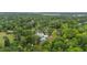 Beautiful aerial view showcasing a home with a pool surrounded by lush, green trees and landscaping at 4205 Cobble Trot Way, Johns Island, SC 29455