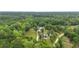Aerial view of home with backyard pool, pond, and surrounded by trees at 4205 Cobble Trot Way, Johns Island, SC 29455