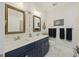 Coastal-themed bathroom featuring double sinks, nautical decor, and elegant lighting fixtures at 4205 Cobble Trot Way, Johns Island, SC 29455