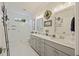 Bright bathroom featuring a gray vanity with double sinks, a tile enclosed shower, and modern decor at 4205 Cobble Trot Way, Johns Island, SC 29455