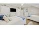 Spacious bedroom features two beds, white dressers, and decor with a 