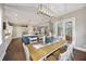 Open floor plan showing a dining room with modern lighting adjacent to the kitchen at 4205 Cobble Trot Way, Johns Island, SC 29455