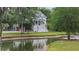 Beautiful home surrounded by lush greenery and a tranquil pond with a fountain at 4205 Cobble Trot Way, Johns Island, SC 29455