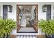 Inviting foyer with grand staircase, hardwood floors, and elegant decor, creating a warm welcome at 4205 Cobble Trot Way, Johns Island, SC 29455
