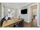 Home office featuring wooden floors, a large desk, and view to staircase and kitchen at 4205 Cobble Trot Way, Johns Island, SC 29455