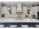 Modern kitchen featuring white cabinets, a large island, and stylish lighting at 4205 Cobble Trot Way, Johns Island, SC 29455