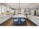 Bright kitchen boasts a large island with seating, stainless appliances, and hardwood floors at 4205 Cobble Trot Way, Johns Island, SC 29455