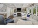 Cozy living room with a fireplace, shelving, coffered ceilings, and hardwood floors at 4205 Cobble Trot Way, Johns Island, SC 29455