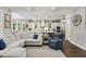 Open-concept living room with comfortable seating and view of the modern kitchen at 4205 Cobble Trot Way, Johns Island, SC 29455