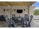 Covered patio with comfortable seating area, tv, and space heater at 4205 Cobble Trot Way, Johns Island, SC 29455