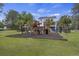 Backyard playground with swing set, slide, and playhouse, with view of in-ground pool at 4205 Cobble Trot Way, Johns Island, SC 29455