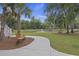 Well-manicured walkway with bench, leading to a scenic pond and fountain, enhancing outdoor enjoyment at 4205 Cobble Trot Way, Johns Island, SC 29455