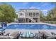 Outdoor pool is surrounded by lounge furniture and lush landscaping, with a covered bar and patio area at 4205 Cobble Trot Way, Johns Island, SC 29455
