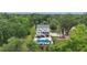 A beautiful rear view of a two-story home with a pool and tropical landscaping in the backyard at 4205 Cobble Trot Way, Johns Island, SC 29455