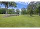 Expansive grassy yard with pond and mature trees offering a serene and picturesque setting at 4205 Cobble Trot Way, Johns Island, SC 29455