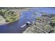 Stunning aerial view of waterway with multiple docks extending along the shore at 4233 Lady Banks Ln, Ravenel, SC 29470