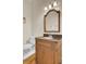 Bathroom with custom vanity, marble countertop, brushed bronze faucet and fixtures, and a white toilet on dark wood floors at 4233 Lady Banks Ln, Ravenel, SC 29470