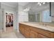 Bathroom with double sink vanity with wooden cabinets, granite countertop, a large mirror, and a walk-in shower at 4233 Lady Banks Ln, Ravenel, SC 29470