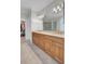 Bathroom with double sink vanity with wooden cabinets, granite countertop, a large mirror, and a walk-in shower at 4233 Lady Banks Ln, Ravenel, SC 29470
