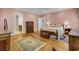 Bedroom with hardwood floors, pink walls, ceiling fan and three dressers with access to a bathroom at 4233 Lady Banks Ln, Ravenel, SC 29470