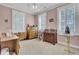 This bedroom features a ceiling fan, natural lighting from the windows, and a desk at 4233 Lady Banks Ln, Ravenel, SC 29470