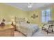 Bedroom with yellow walls, a ceiling fan, and large windows with shutter blinds at 4233 Lady Banks Ln, Ravenel, SC 29470