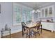 A bright dining area has a large window and built in cabinets at 4233 Lady Banks Ln, Ravenel, SC 29470