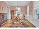 Classic dining room with pink walls, hardwood flooring, and vintage decor at 4233 Lady Banks Ln, Ravenel, SC 29470