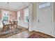 Bright dining room with hardwood floors, wainscoting, and a table set for a meal at 4233 Lady Banks Ln, Ravenel, SC 29470