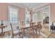 Elegant dining area with period furniture, chandelier, and lots of natural light at 4233 Lady Banks Ln, Ravenel, SC 29470