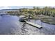 Aerial view of private dock with covered seating and boat access on the waterway at 4233 Lady Banks Ln, Ravenel, SC 29470